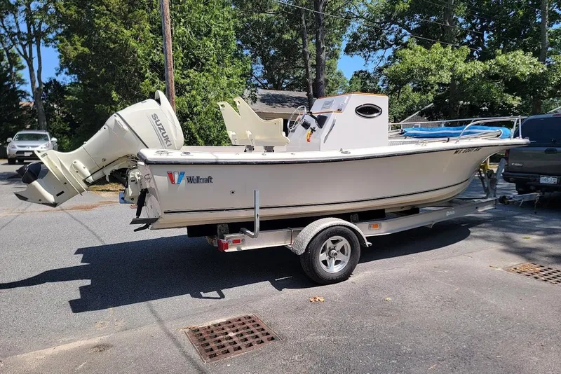 Slide: The Image of 1978 Wellcraft V-20 Steplift boat on trailer, parked outdoors with Suzuki outboard motor. - 17
