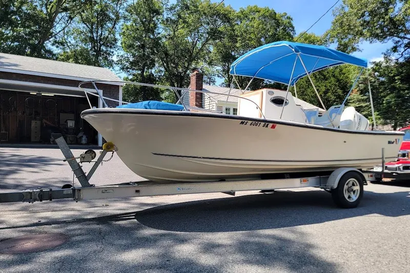 Slide: The Image of 1978 Wellcraft V-20 Steplift boat on trailer with blue canopy, parked outdoors. - 21