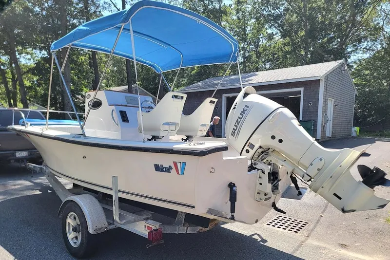 Slide: The Image of 1978 Wellcraft V-20 Steplift boat with Suzuki outboard motor and blue canopy on trailer. - 11