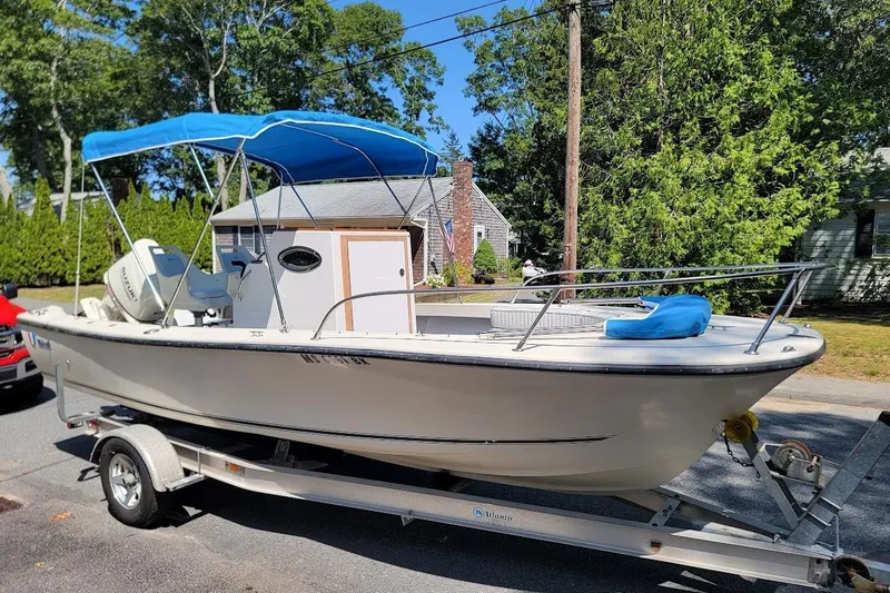 Slide: The Image of 1978 Wellcraft V-20 Steplift boat on trailer with blue canopy, parked in residential area. - 25