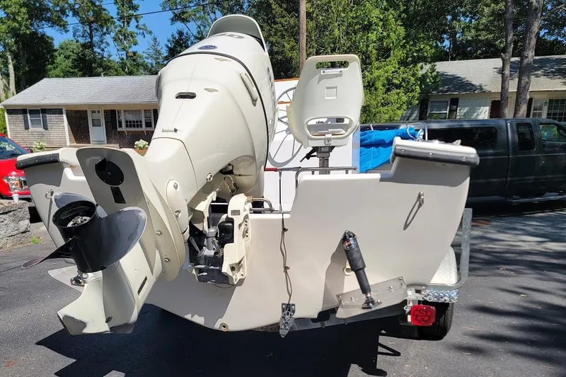 Slide: The Image of 1978 Wellcraft V-20 Steplift boat with outboard motor, parked on a driveway. - 26