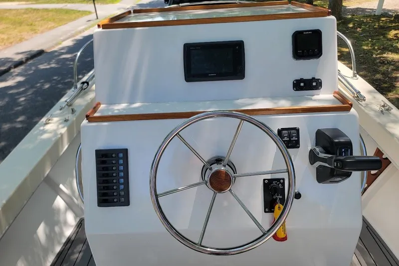 Slide: The Image of 1978 Wellcraft V-20 Steplift boat helm with steering wheel and control panel. - 14