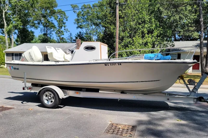 Slide: The Image of 1978 Wellcraft V-20 Steplift boat on trailer, parked on a residential street. - 16