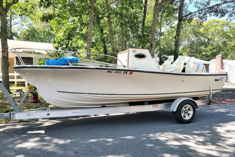 The Image of 1978 Wellcraft V-20 Steplift boat on trailer, parked outdoors near trees. - 0