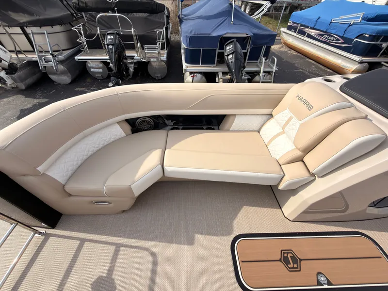 Slide: The Image of The image shows the beige and cream seating area of a Harris Grand Mariner 230 boat. - 16