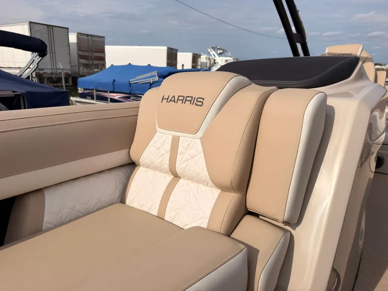Slide: The Image of Beige upholstery with "Harris" logo on a boat seat, surrounded by other boats in the background. - 21