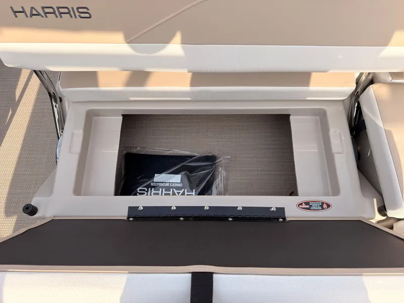 Slide: The Image of An open storage compartment on a Harris Grand Mariner 230 boat, with a bag inside. - 46