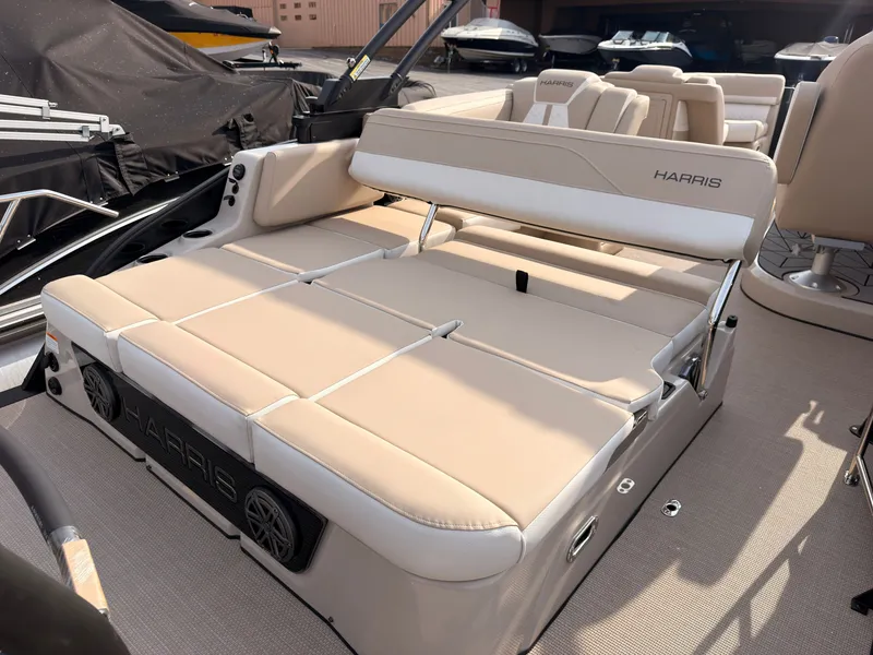 Slide: The Image of The image shows the beige lounge seating of a 2027 Harris Grand Mariner 230. - 39