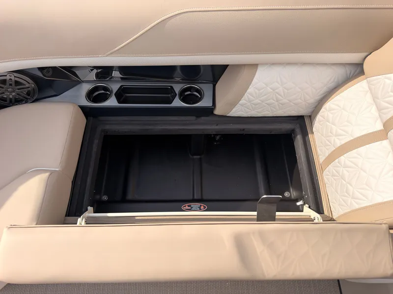 Slide: The Image of A sleek storage compartment in the 2027 Harris Grand Mariner 230 with cushioned seats and cup holders. - 20