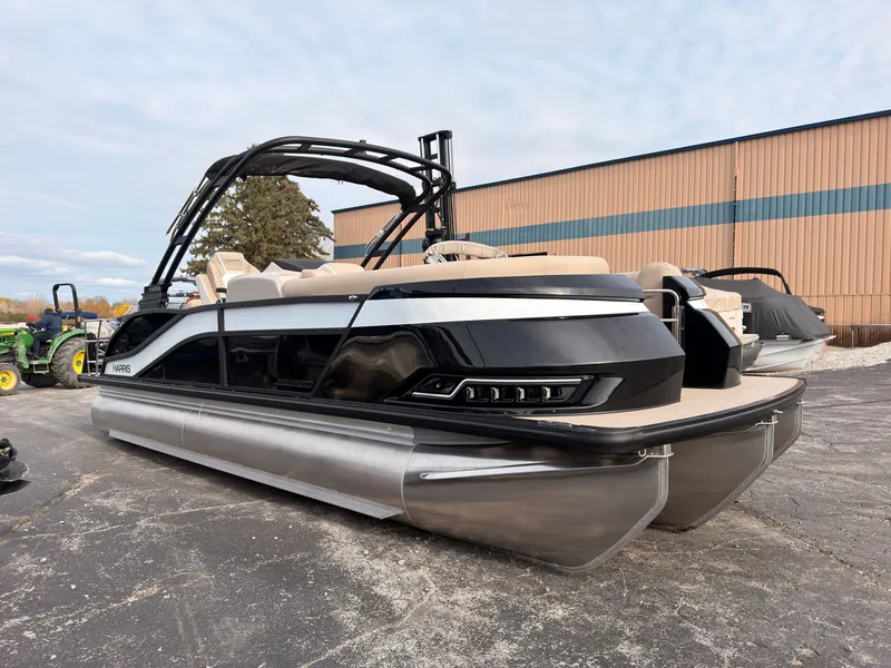 The Image of 2027 Harris Grand Mariner 230 with sleek design, black hull, and beige interior. - 0