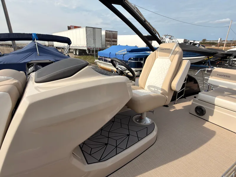 Slide: The Image of The image shows the cockpit of a 2027 Harris Grand Mariner 230 with a sleek helm seat. - 26