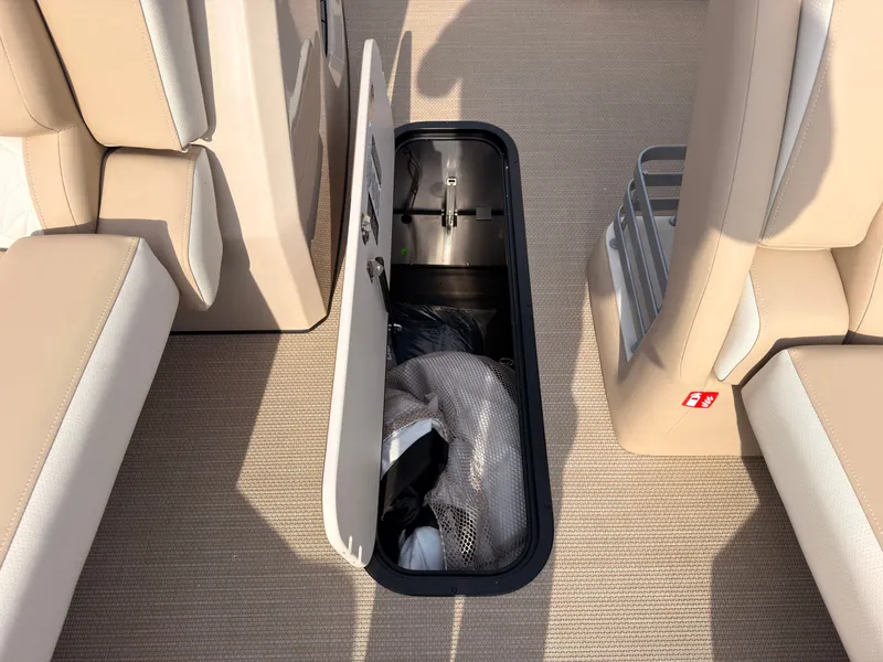 Slide: The Image of In-floor storage compartment on a 2027 Harris Grand Mariner 230. - 23