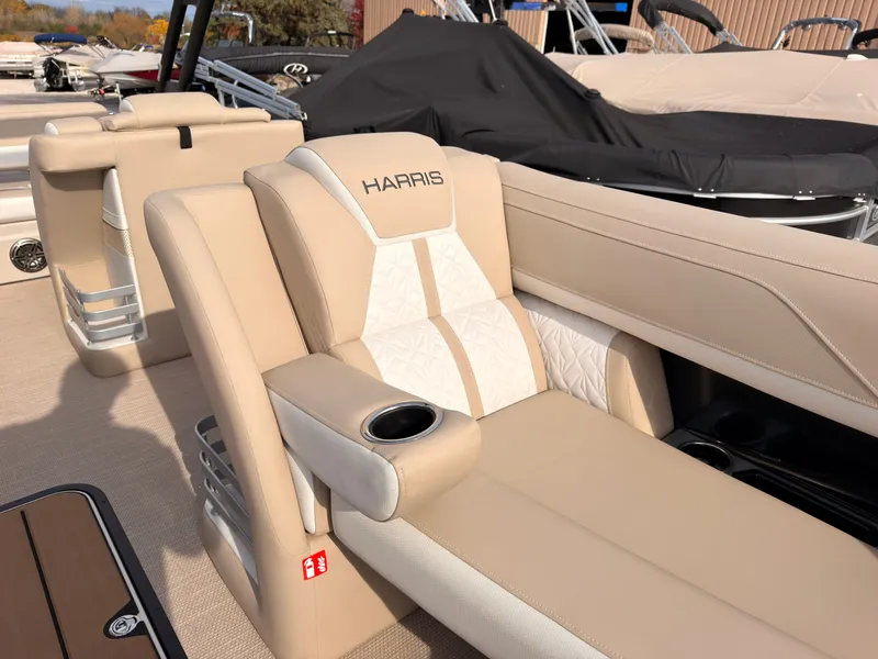 Slide: The Image of Luxurious seating area on a Harris Grand Mariner 230 pontoon boat with beige upholstery and cup holder. - 14