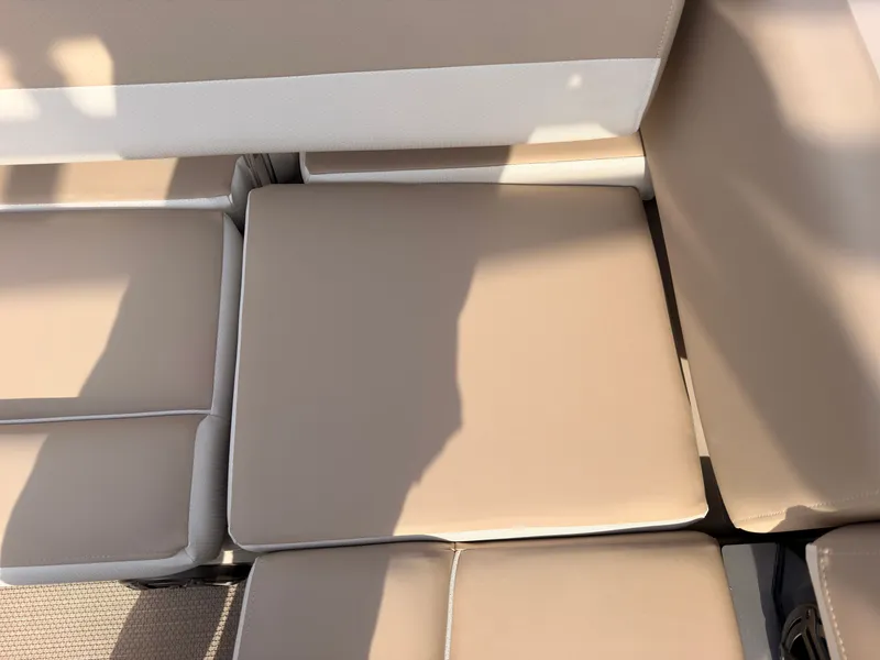 Slide: The Image of Beige upholstery on a boat seat with shadows and textured flooring. - 45