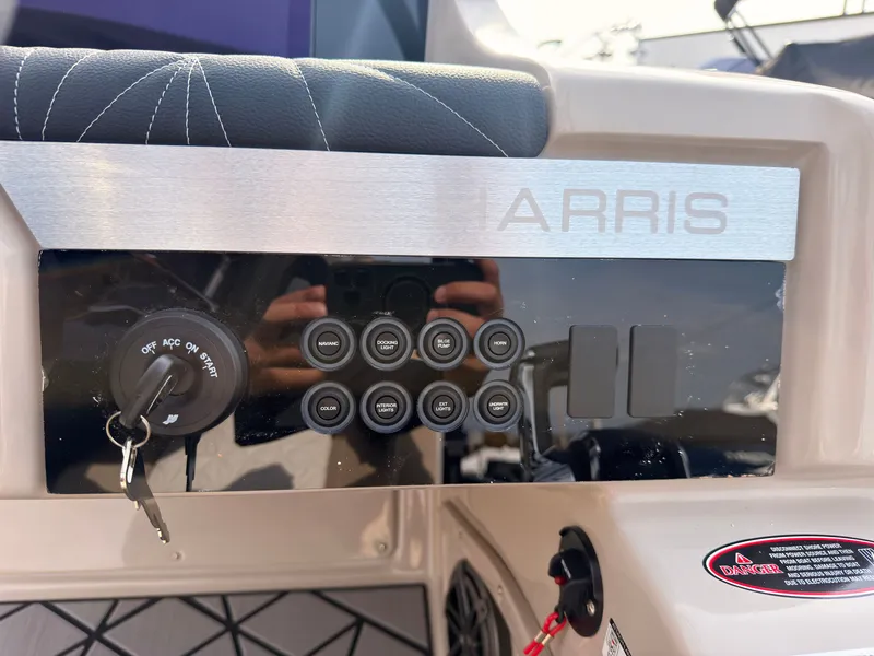 Slide: The Image of Close-up of a Harris Grand Mariner 230 console with switches and ignition key. - 30