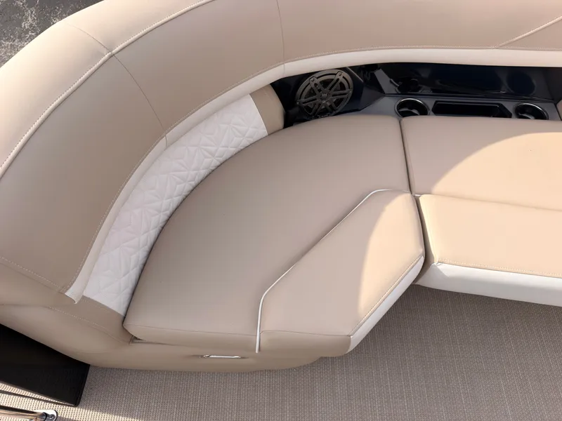Slide: The Image of Beige upholstered seating with white accents and a speaker in a boat. - 17