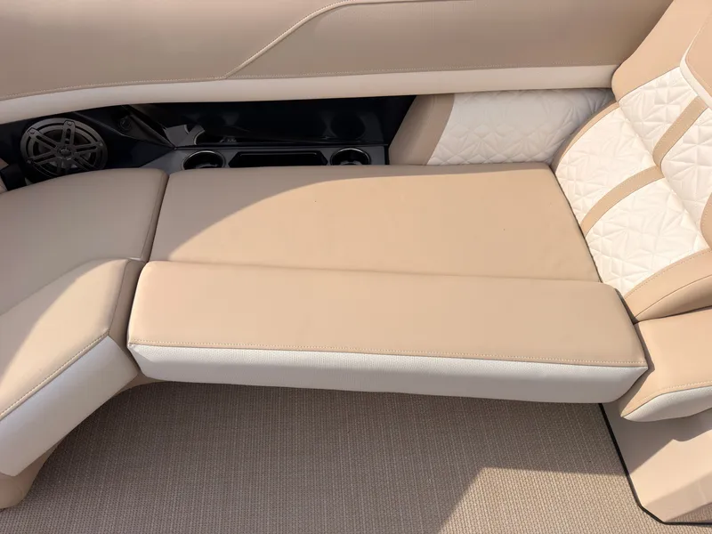 Slide: The Image of Beige and white upholstery on a boat seat with speaker and cup holders. - 19