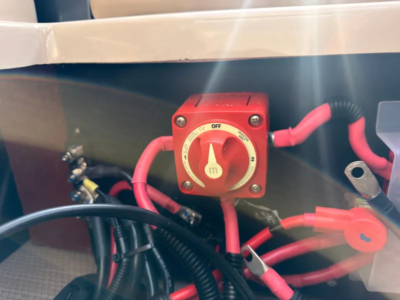 Slide: The Image of A red battery switch with cables in a boat. - 38