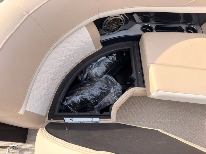 Slide: The Image of A sleek seating area with storage underneath, beige upholstery, and a speaker. - 18