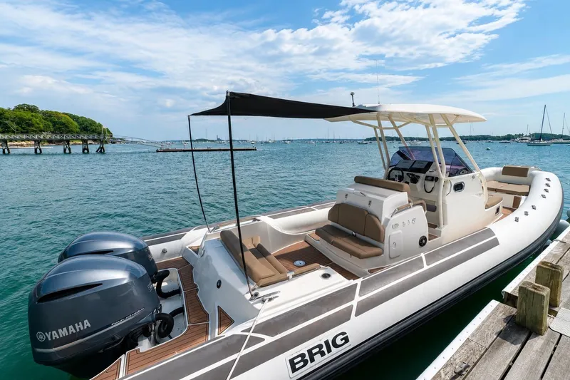 Slide: The Image of 2021 Brig Eagle 10 boat docked with Yamaha engines, under a clear blue sky. - 3