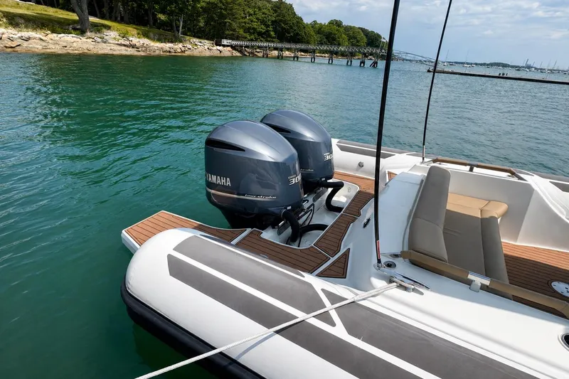 Slide: The Image of 2021 Brig Eagle 10 boat with twin Yamaha engines on a calm lake. - 10