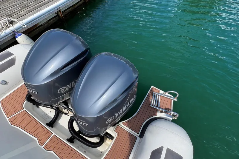 Slide: The Image of 2021 Brig Eagle 10 boat with dual Yamaha outboard motors docked on clear water. - 12