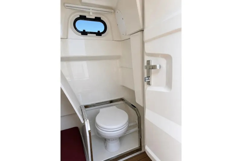 Slide: The Image of 2021 Brig Eagle 10 boat interior bathroom with compact toilet and window. - 23