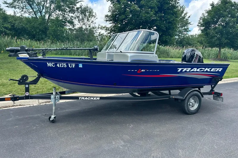 The Image of 2018 Tracker Pro Guide V-16 WT boat on trailer, parked outdoors. - 0