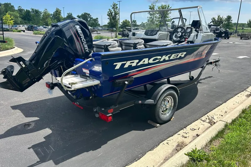 Slide: The Image of 2018 Tracker Pro Guide V-16 WT boat on trailer in parking lot. - 13