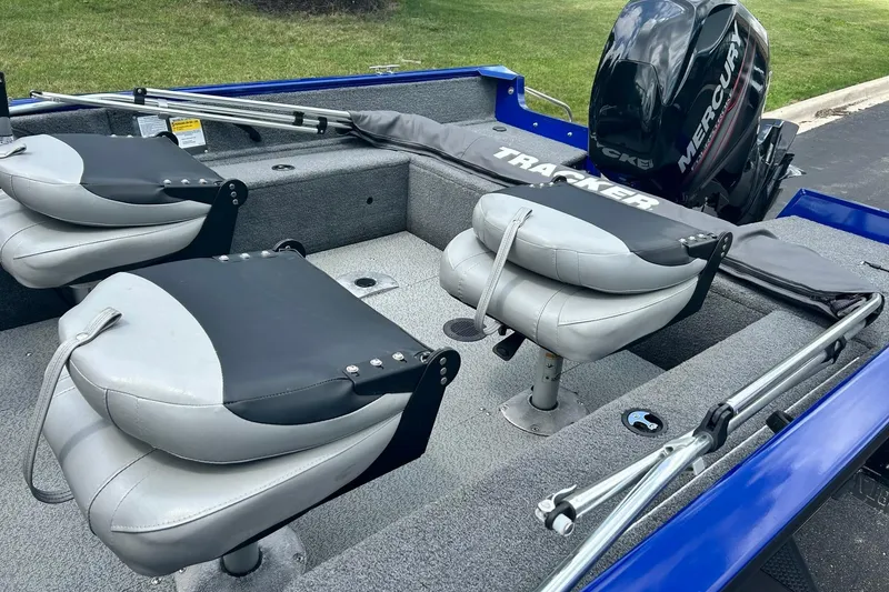Slide: The Image of 2018 Tracker Pro Guide V-16 WT boat interior with seating and Mercury outboard motor. - 7