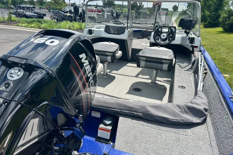 Slide: The Image of 2018 Tracker Pro Guide V-16 WT boat with Mercury 60 engine, featuring dual seats and steering console. - 11