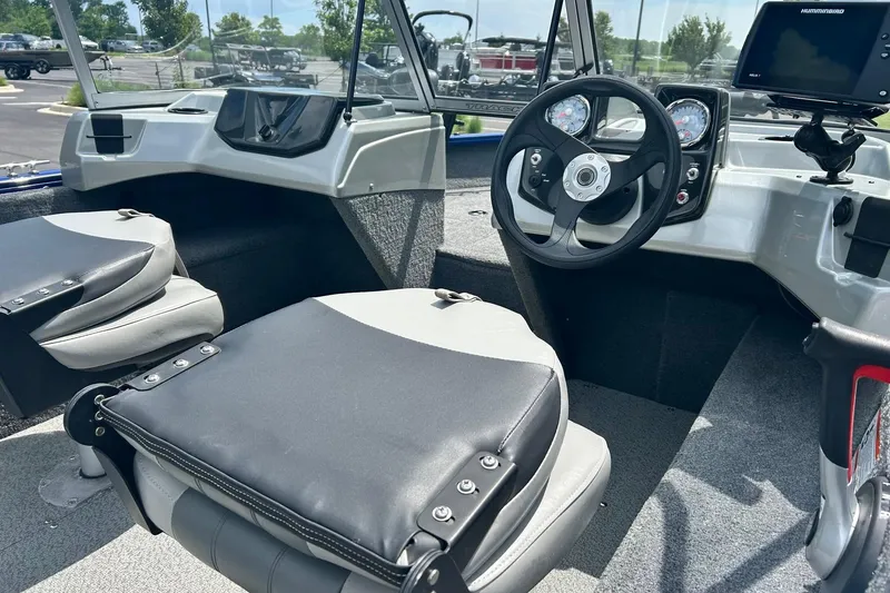 Slide: The Image of 2018 Tracker Pro Guide V-16 WT boat interior with steering wheel and seating. - 8