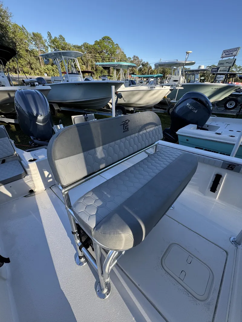 Slide: The Image of A 2026 Carolina Skiff 23 LS with gray upholstery and a modern design. - 9