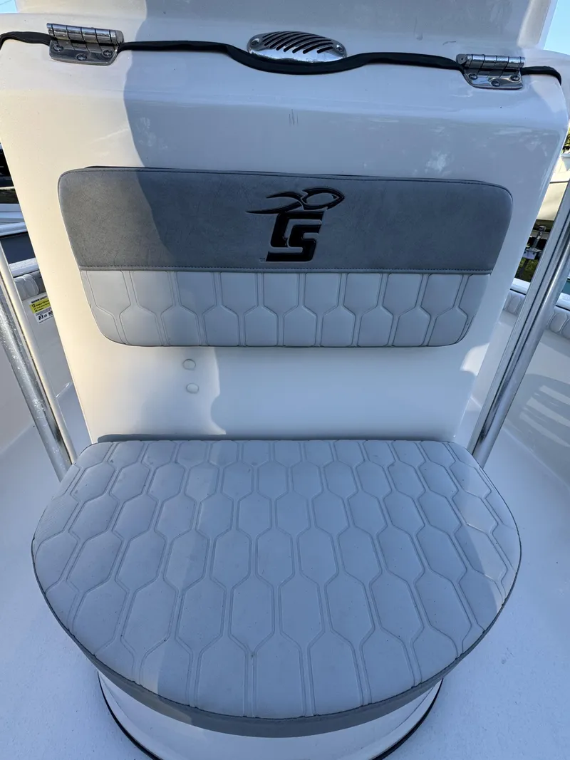 Slide: The Image of A cushioned seat with gray and white pattern on a Carolina Skiff 23 LS boat. - 16