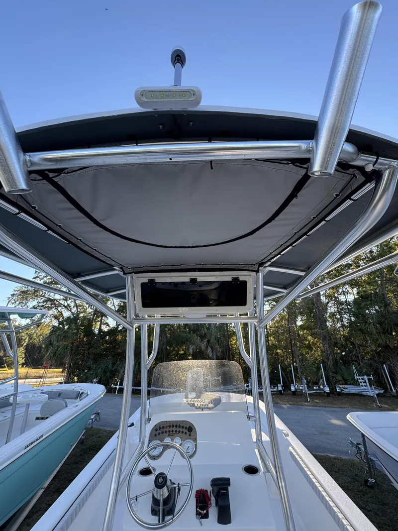 Slide: The Image of The image shows the cockpit of a Carolina Skiff 23 LS with a T-top and helm console. - 5