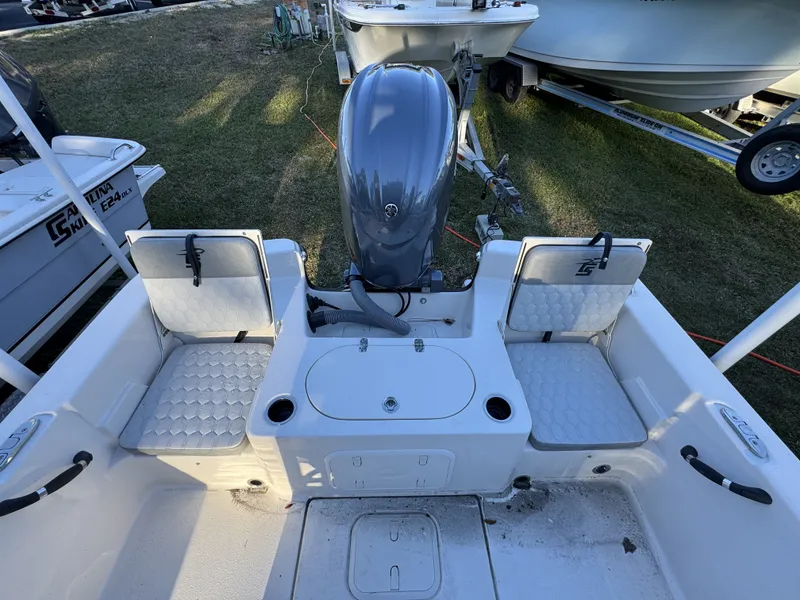Slide: The Image of The image shows the stern of a Carolina Skiff 23 LS boat with an outboard motor and seating. - 3