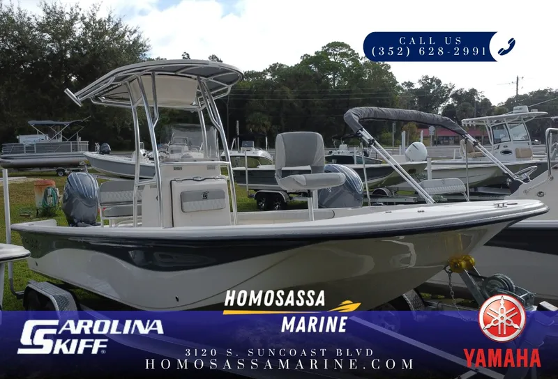 The Image of A Carolina Skiff 23 LS boat is on a trailer in an outdoor area. - 1