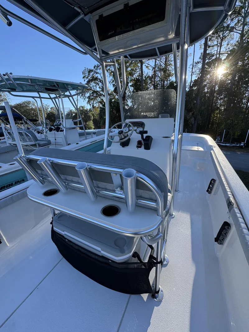 Slide: The Image of The image shows the cockpit of a 2026 Carolina Skiff 23 LS with a helm and rod holders. - 10