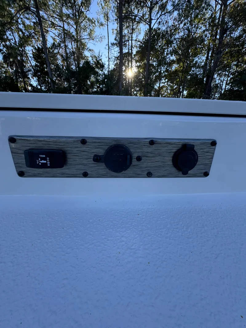 Slide: The Image of A control panel on a Carolina Skiff 23 LS boat, surrounded by trees in the background. - 20