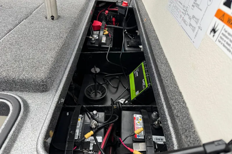 Slide: The Image of 2020 Ranger Z175 boat battery compartment with wiring and charger setup. - 15