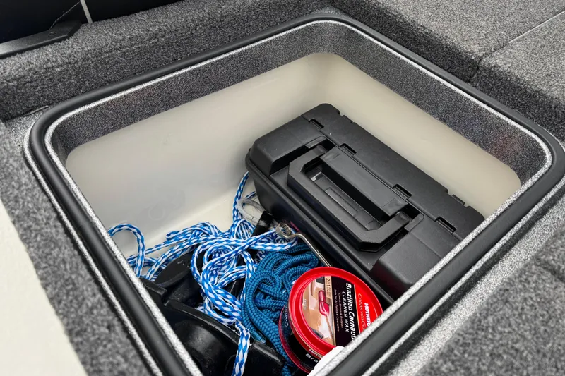 Slide: The Image of Storage compartment in 2020 Ranger Z175 boat with rope, toolbox, and fishing line. - 14