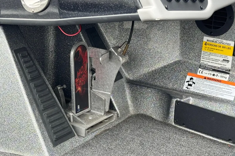 Slide: The Image of Foot pedal control in a 2020 Ranger Z175 boat cockpit with capacity warning labels. - 12