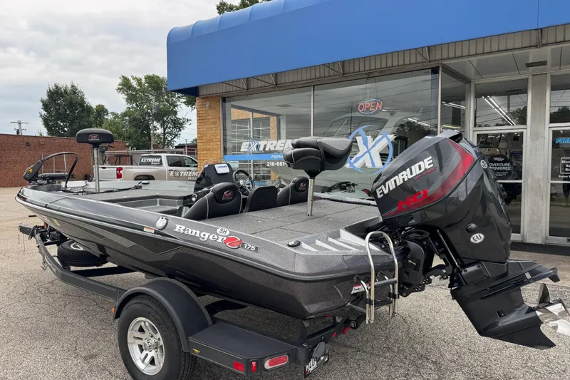 Slide: The Image of 2020 Ranger Z175 boat with Evinrude motor parked outside dealership. - 2