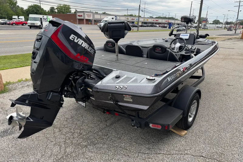 Slide: The Image of 2020 Ranger Z175 boat with Evinrude motor, parked on a trailer in a commercial area. - 4