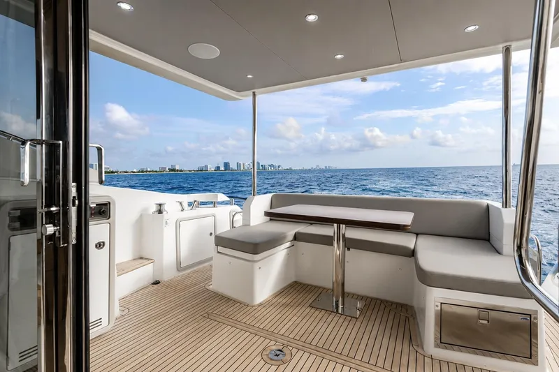 Slide: The Image of Luxurious 2016 Azimut 50 yacht deck with seating, ocean view, and city skyline in the background. - 31