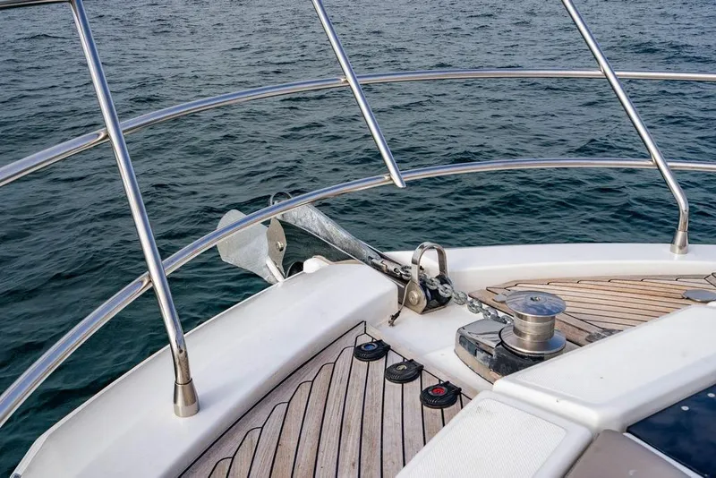 Slide: The Image of Bow of a 2016 Azimut 50 yacht with anchor and railing over water. - 12