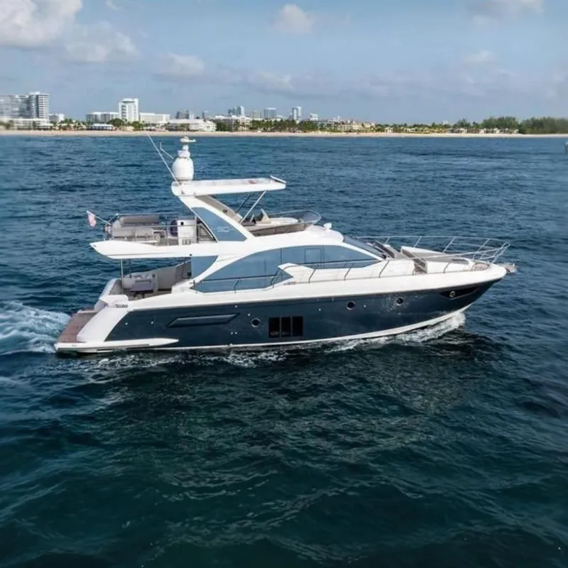 Slide: The Image of A luxurious 2016 Azimut 50 yacht cruising on open water with a city skyline in the background. - 4