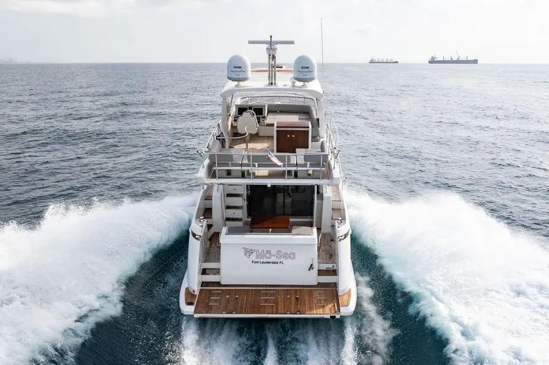 Slide: The Image of 2016 Azimut 50 yacht cruising on open sea, rear view. - 5