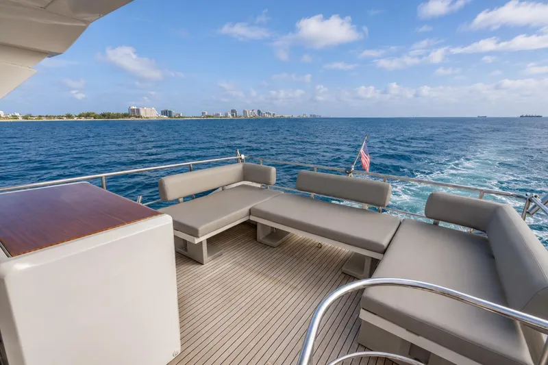 Slide: The Image of Luxurious 2016 Azimut 50 yacht deck with seating, ocean view, and city skyline in the background. - 33