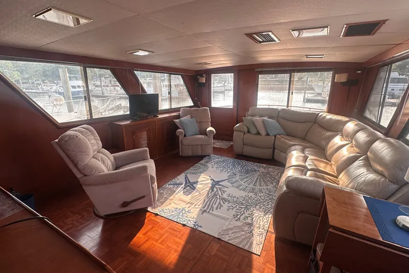 Slide: The Image of Luxurious interior of 1989 Jefferson Marquessa 52 yacht with plush seating and large windows. - 10